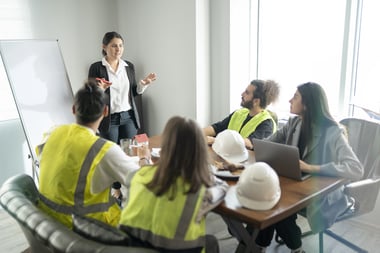 Construction manager talking to a room of construction workers.