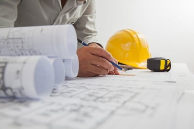 Blueprints on a table being drawn on