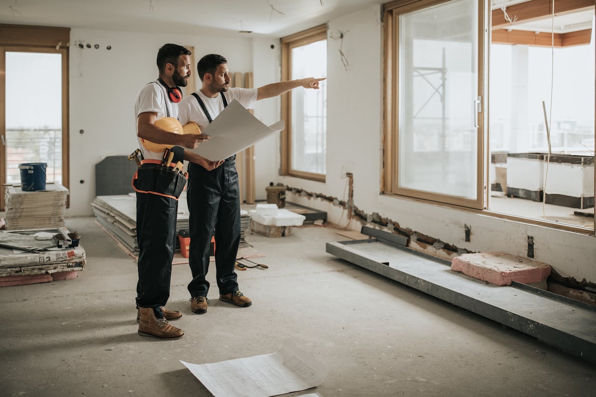 Two construction workers during a building renovation.